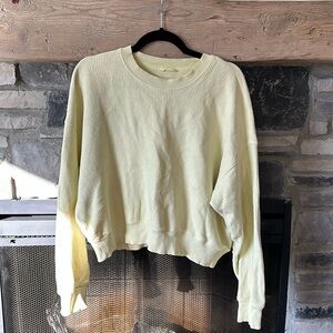 Pale yellow crewneck.